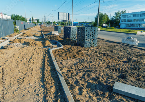 Schilderij op canvas Urban sidewalk construction site with curbstones and drainage boxes