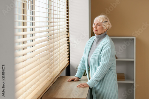 Thoughtful senior woman nea...