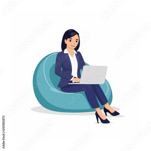 Woman in suit working on laptop while sitting on bean bag chair