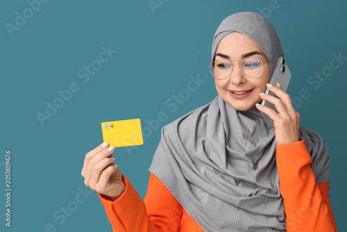 Muslim woman with credit ca...