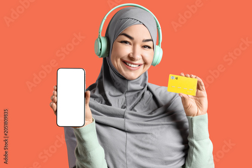 Muslim woman in headphones ...