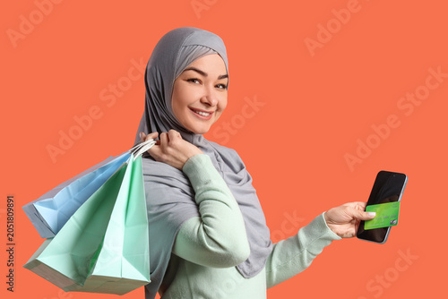 Muslim woman with mobile ph...