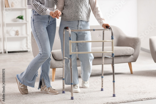 Mature woman with walker an...