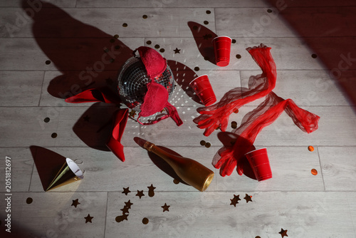 Sticker After party mess with disco ball, bra and high heels on wooden floor