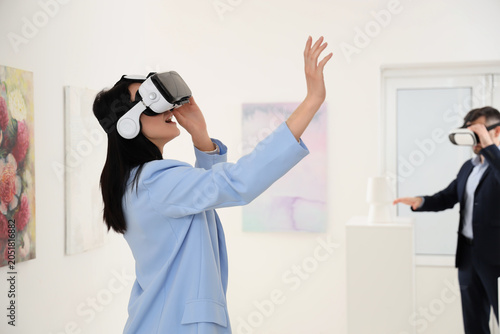 Young woman using VR glasse...