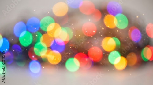 Vibrant colorful bokeh lights create an abstract background with glowing orbs.