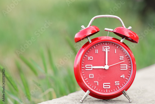 Red alarm clock on sidewalk...