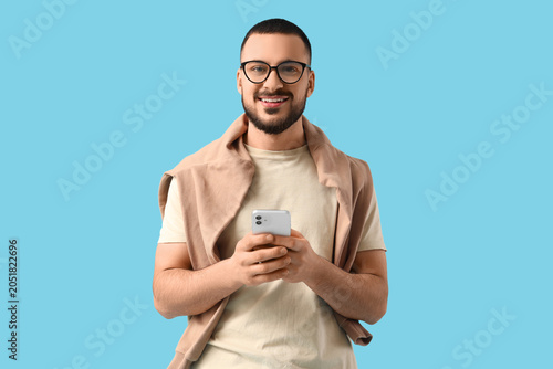 Happy young man with mobile...
