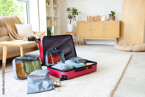 Open suitcase with travelli...