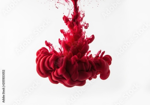 Red ink swirling in water isolated on white background