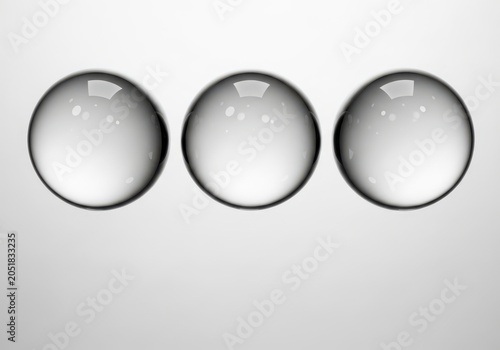 Three transparent glass spheres isolated on white background