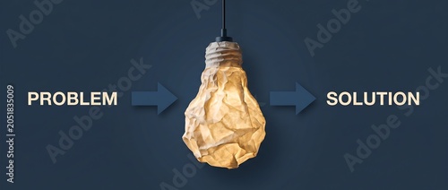 Lightbulb transformed from crumpled paper represents a brilliant idea or innovation solving a problem and leading to a successful solution.