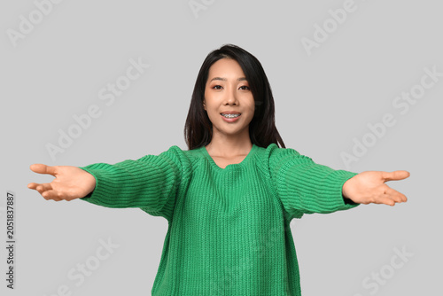 Young Asian woman opening a...