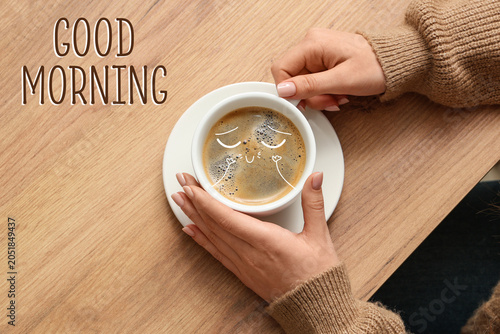 Woman holding cup of coffee...