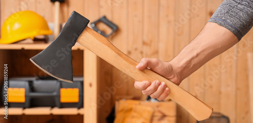 Man holding sharp steel axe...