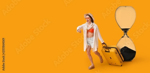 Bild auf Leinwand Young woman rushing with luggage and hourglass, time pressure for travel, vacati
