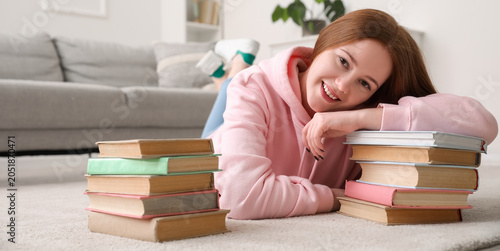 Teenage girl with stacks of...