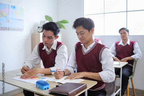 Canvastavla Asian High School Students in Red Vest Uniforms Studying Together, Writing in No