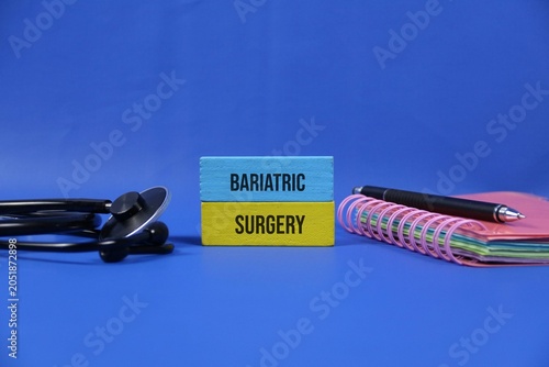 Bariatric Surgery Concept With Stethoscope Notebook And Pen On dark blue Background For Weight Loss.