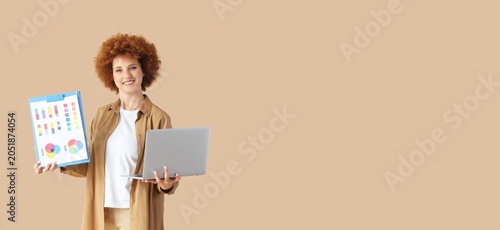 Smiling woman holding lapto...