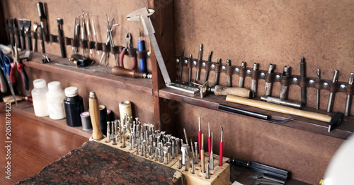 Photos Set of tools for work with leather in workshop