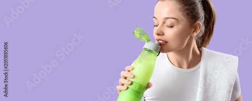 Bild auf Leinwand Young woman hydrating with green water bottle after workout, fitness and wellnes