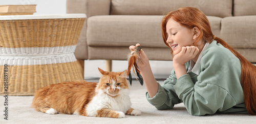 Redhead teenage girl playin...