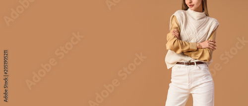 Stylish young woman in beig...