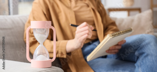 Hourglass against woman wri...