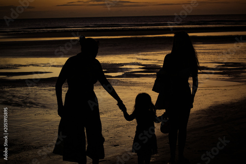 Family silhouettes holding hands at sunset in Jericoacoara