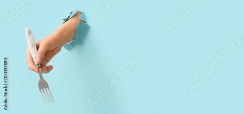 Hand holding silver fork th...
