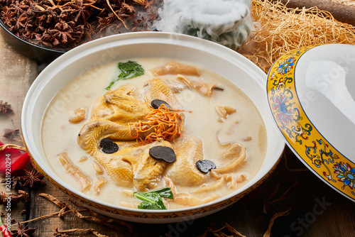 Fotografie Fish maw, kudzu root, and stewed free-range chicken soup in a round porcelain bo