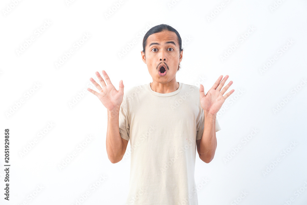 Naklejka premium Young Asian man in a shirt, with a shocked face expression. Isolated on a white background