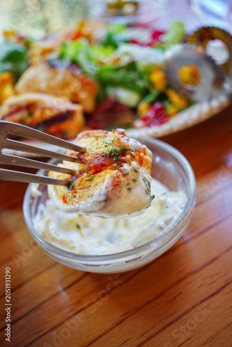 Dip grilled chicken breast in white sauce