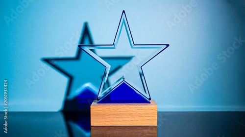 Silver star award trophy representing excellence achievement and recognition on blue background