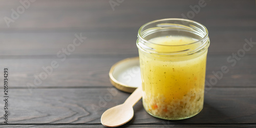 Фотография Chicken soup with starlet pasta in a glass jar on the table