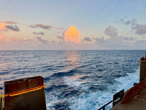 Bilde på lerret Ocean wake trailing behind a moving vessel during sunset