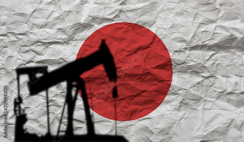 Oil Pump Jack Silhouette Over Wrinkled Japan Flag Background. Oil crisis in Japan.