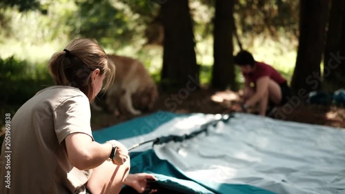 Mother With Child Setting Up A Camping Tent In A Forest Campground In The Woodland Camp
