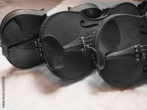 Three Beautiful Wooden violins with chinrest,show detail of acoustic instrument,