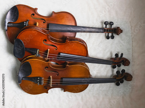 Three Beautiful Wooden violins with chinrest,put together,show detail of acoustic instrument,