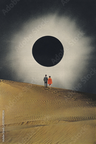 Photography The couple is walking up a desert dune to get a clear view of the total solar ec