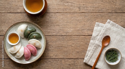 Songpyeon traditional Korean rice cakes top view food photography on wooden background