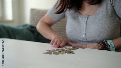 Girl Collects Coins In A Handful On A Table