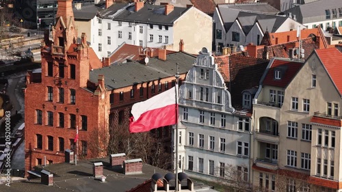 Polish Flag Flying Above Poznan Old Town Skyline, amazing aerial view from spot view above city center