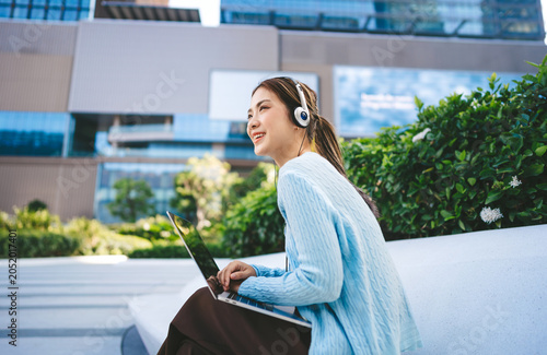 Beautiful young adult business asian woman hand typing keyboard looking at laptop freelance work from anywhere modern lifestyles