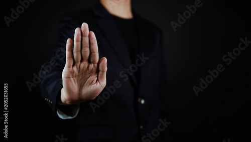 Картината върху платно Business professional showing a stop hand gesture, symbolizing prohibition, rejection, security, compliance, risk prevention, fraud protection, privacy control, warning, boundary setting