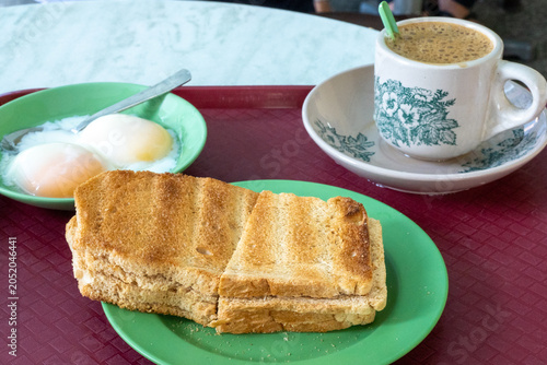Traditional Singaporean Breakfast with Kaya Toast, Soft Boiled Eggs and Kopi