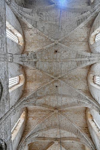 Direct low-angle view looking straight up at the impressive medieval Gothic ribbed vaulted stone ceiling of Bugday Camii, also historically known as the Church of St. Peter and St. Paul, in Famagusta.