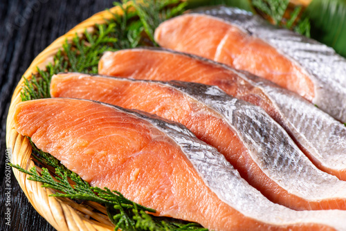 Fresh Salmon Fillets Arranged on Bamboo Zaru Basket with Japanese Hiba Cypress Traditional Presentation
